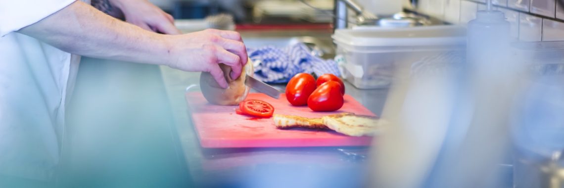 person slicing tomatoes